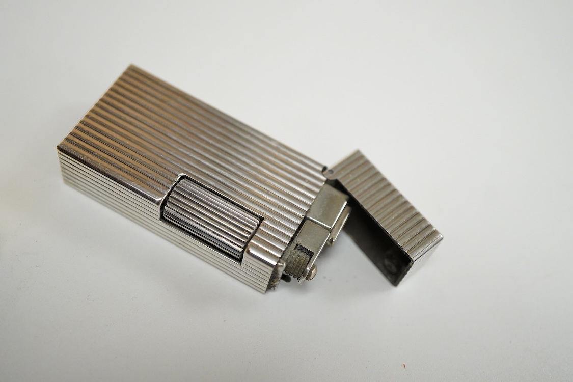 Three assorted plated Dunhill lighters and a gilt example, largest 6.5cm high